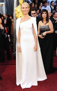 Gwyneth Paltrow at the 2012 Oscars in an all white Tom Ford gown with a floor-length cape. (Photo by Pinterest)
