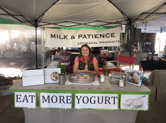 Stephanie Gilewicz, owner of Milk + Patience, poses at her stall at the market.png