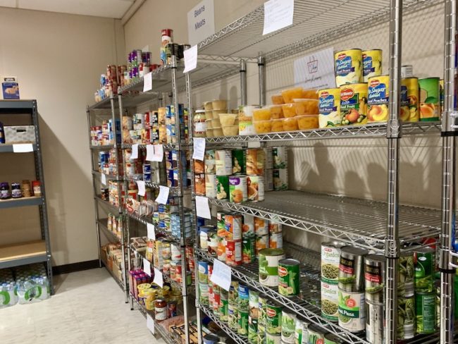 Recipe ideas from the Highland Park High School group Combat Hunger Our Way (C.H.O.W) hang from the shelves.