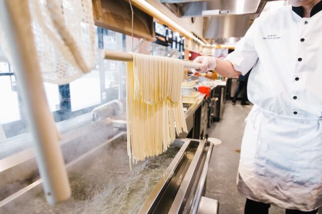 A chef prepares udon noodles. Image courtesy of Marugame Udon.