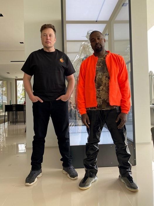 Elon Musk poses with Kanye West after a link-and-build session.