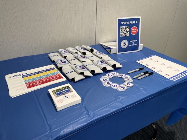 Student Transfer Table event at SMU with flyers and coozies and promotional materials.